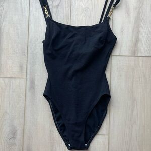Elegant black one piece with chain detail